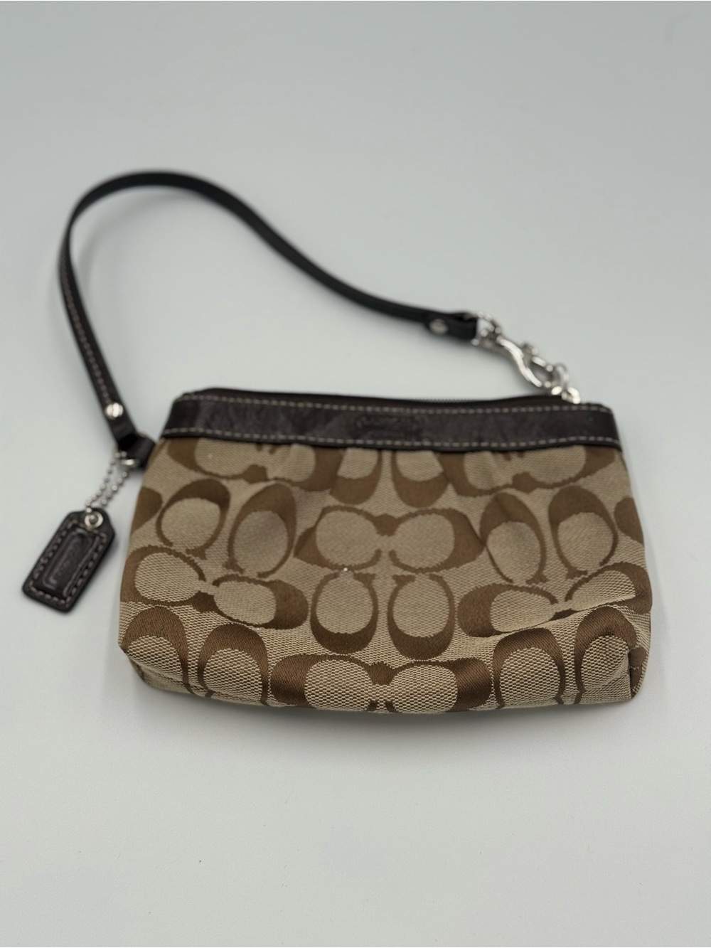 coach canvas monogram and leather wristlet in brown and tan